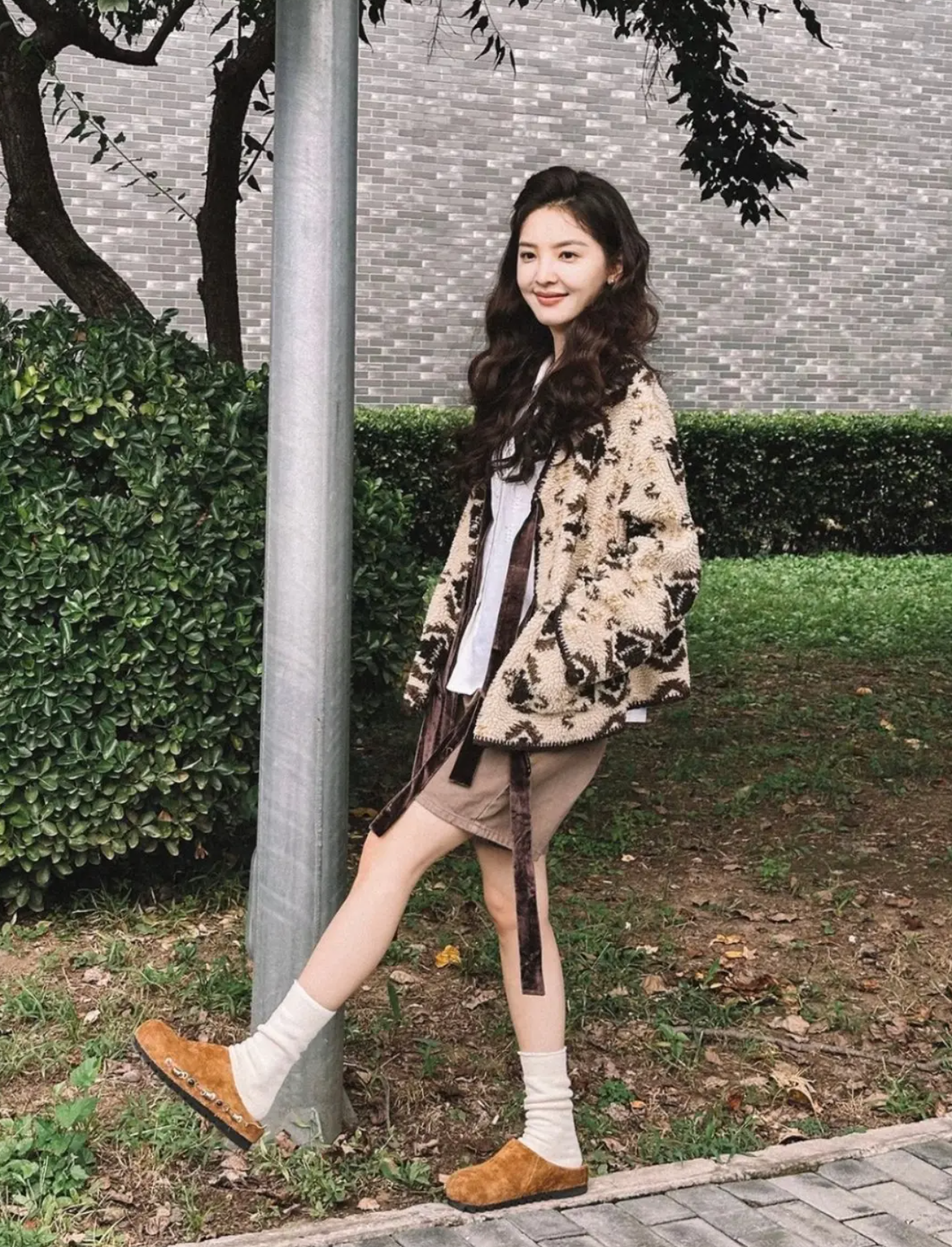 Chic metal buckle slides paired with casual shorts and a sweater