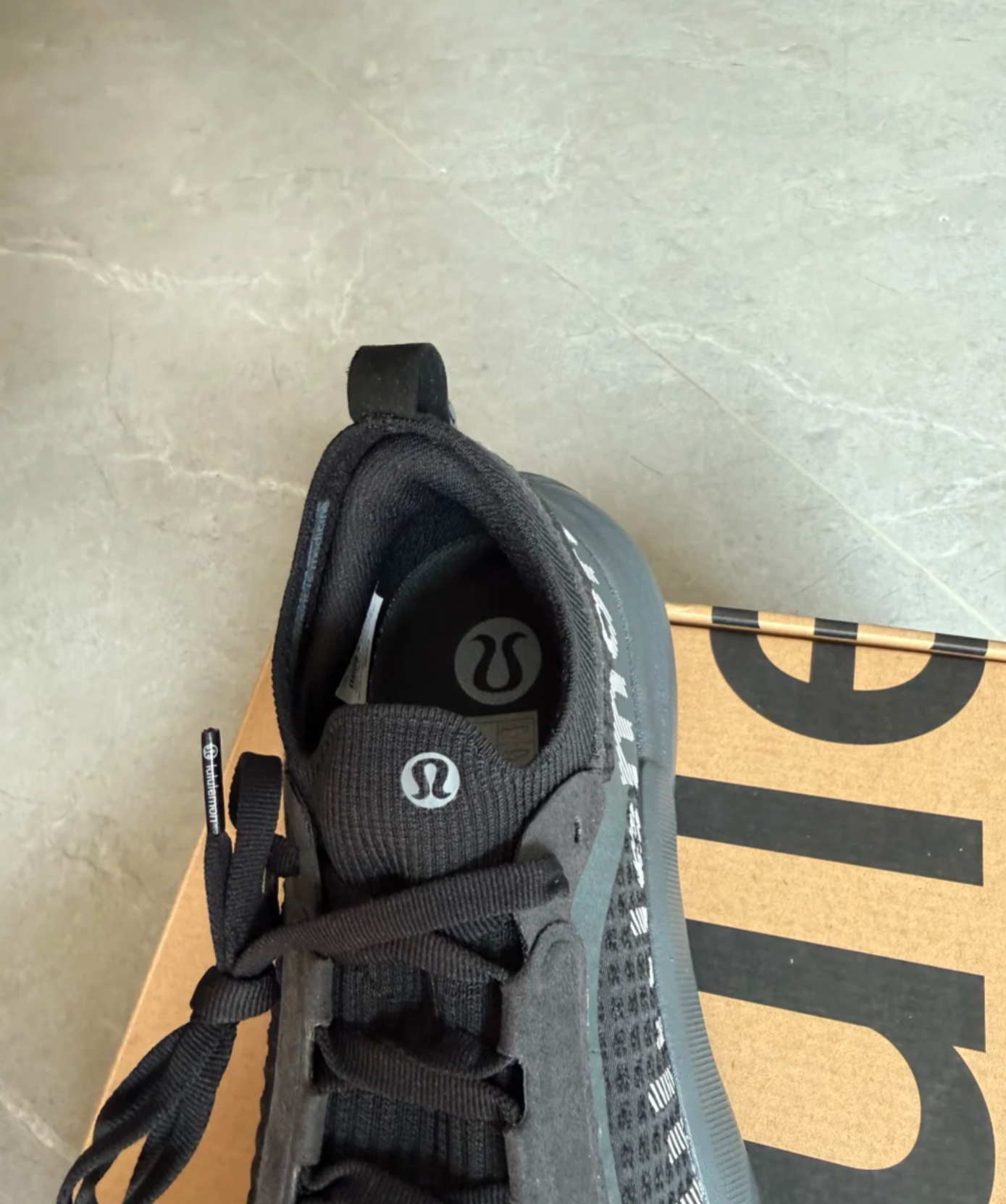 Detail shot of movement is medicine text on lululemon shoes