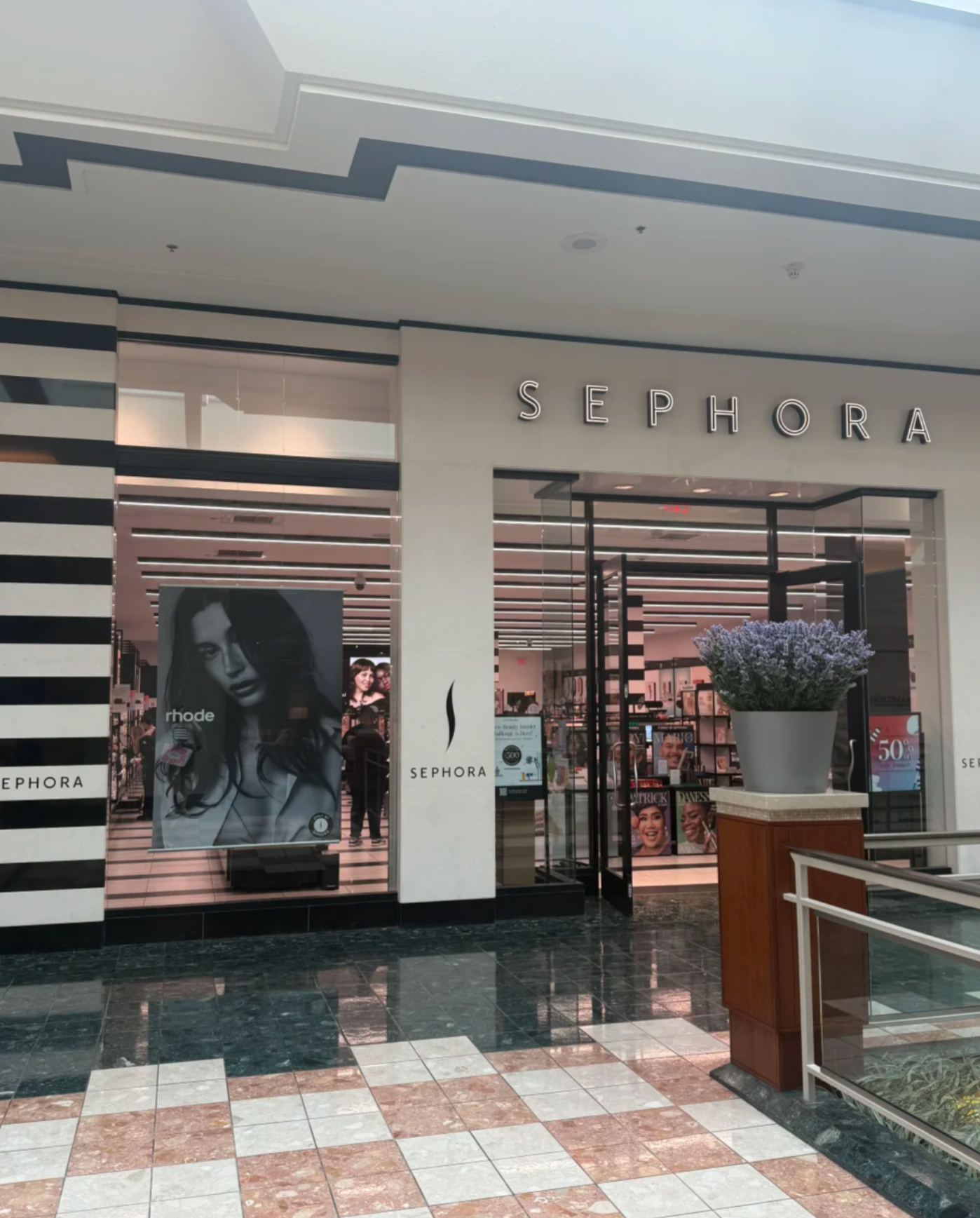 A vibrant display of Rhode products prominently featured at the front of a Sephora store.