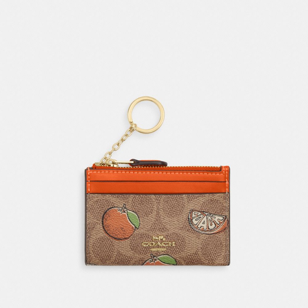 coach mini skinny id case in signature canvas with orange print CAR21-IMTAM