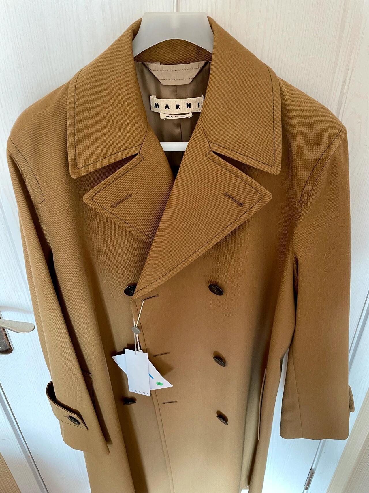 Close up of Marni coat fabric and black stitch detailing