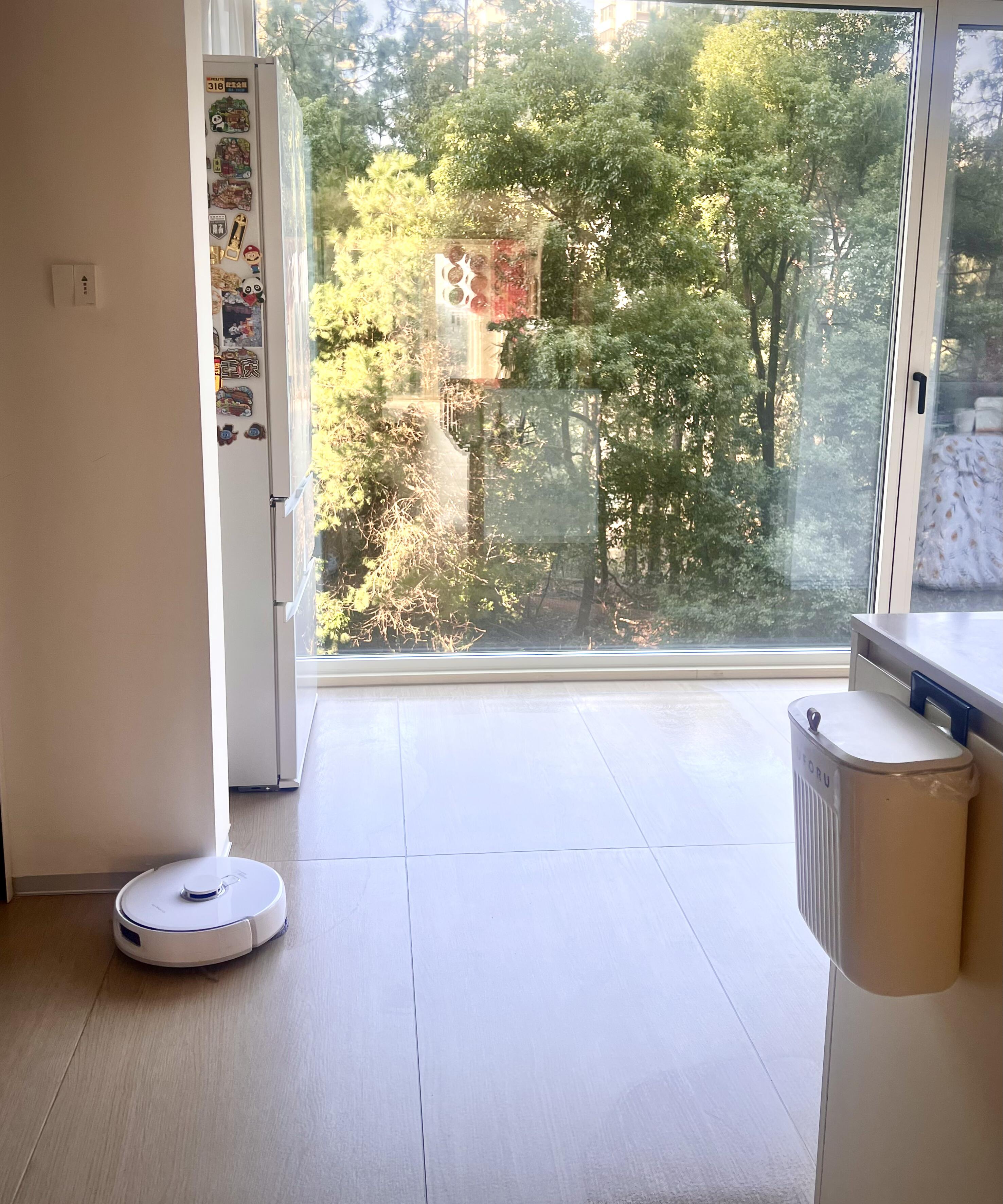 A robot vacuum cleaning underneath a bed in a tight, difficult-to-reach space, illustrating deep cleaning.