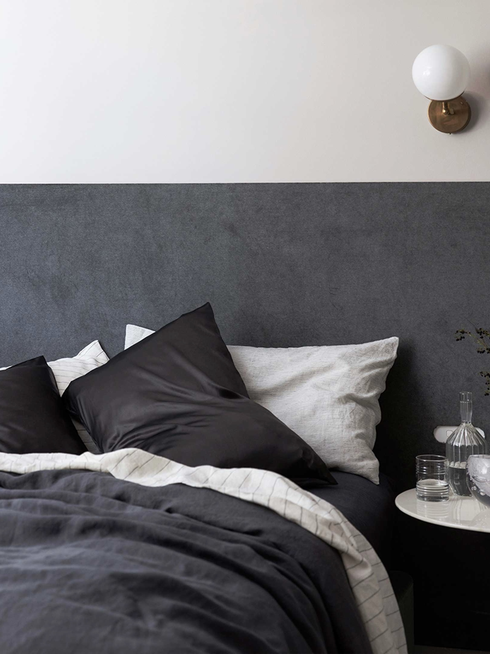 A perfectly made bed featuring Cultiver linen