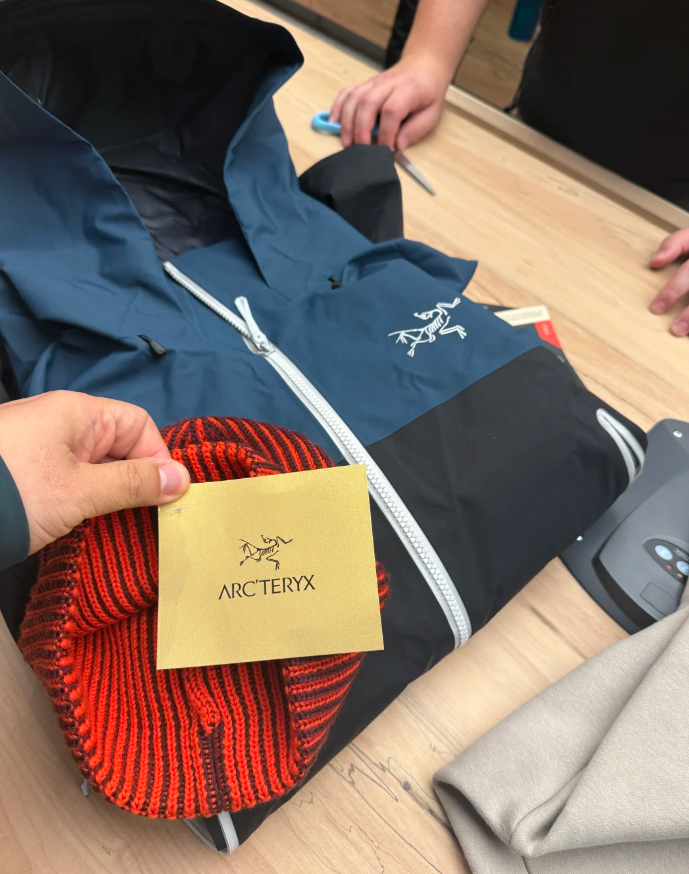 A shot of the bustling Arc'teryx pop-up store queue in a city setting, emphasizing the early morning crowd and the effort to get a free item.