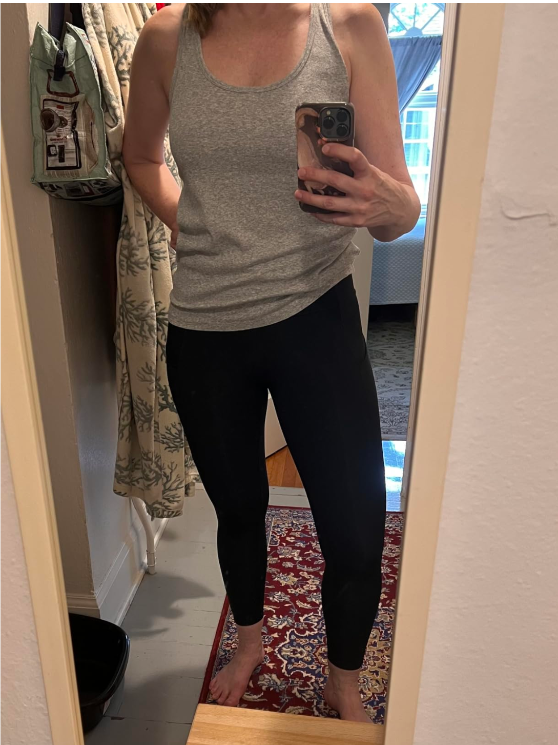 Woman wearing CRZ YOGA high waisted leggings and sports bra with a full zip jacket lookalike