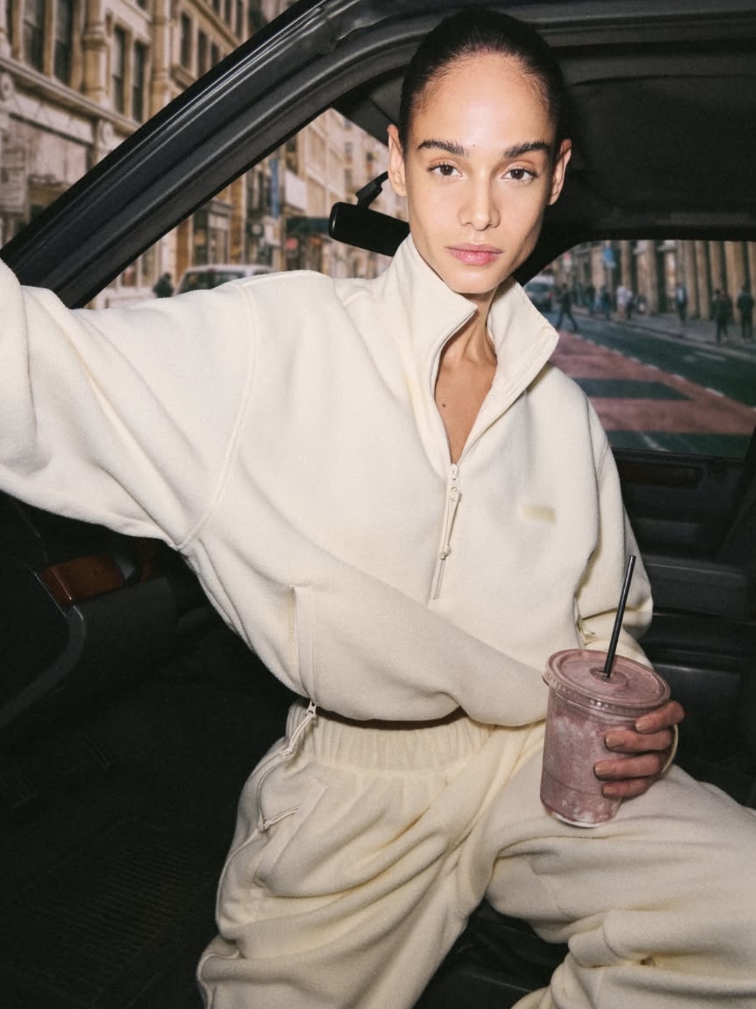 SKIMS Cozy knit faux fur coat in off-white/cream color.