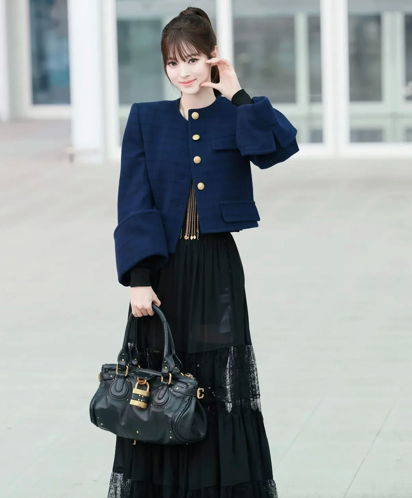 Woman wearing a Chloe padlock bag.