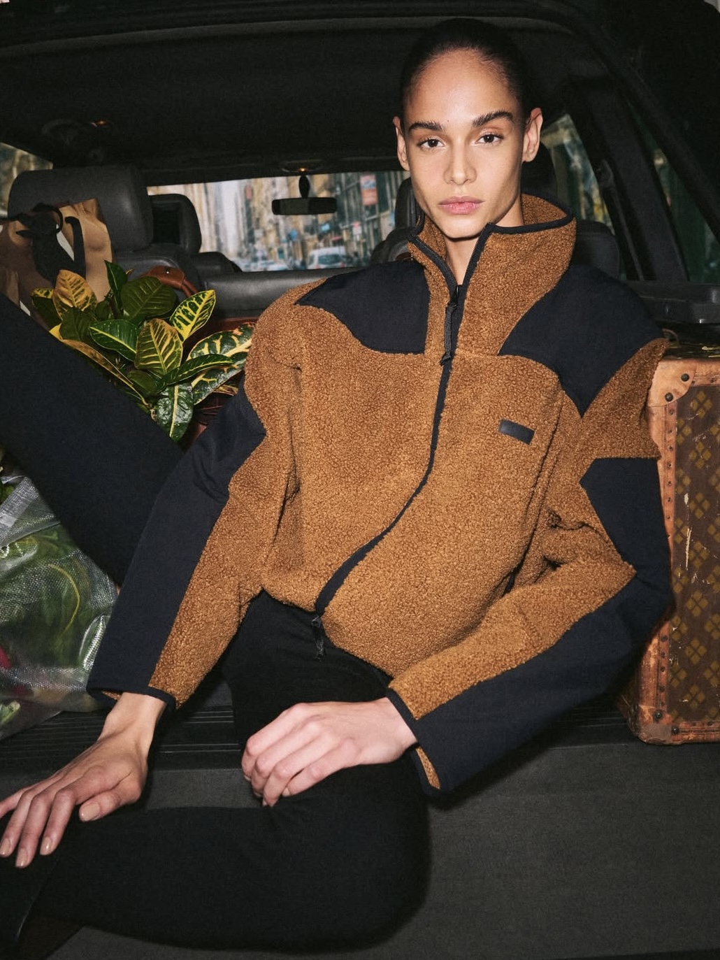 SKIMS Teddy coat in a deep brown/tan color.